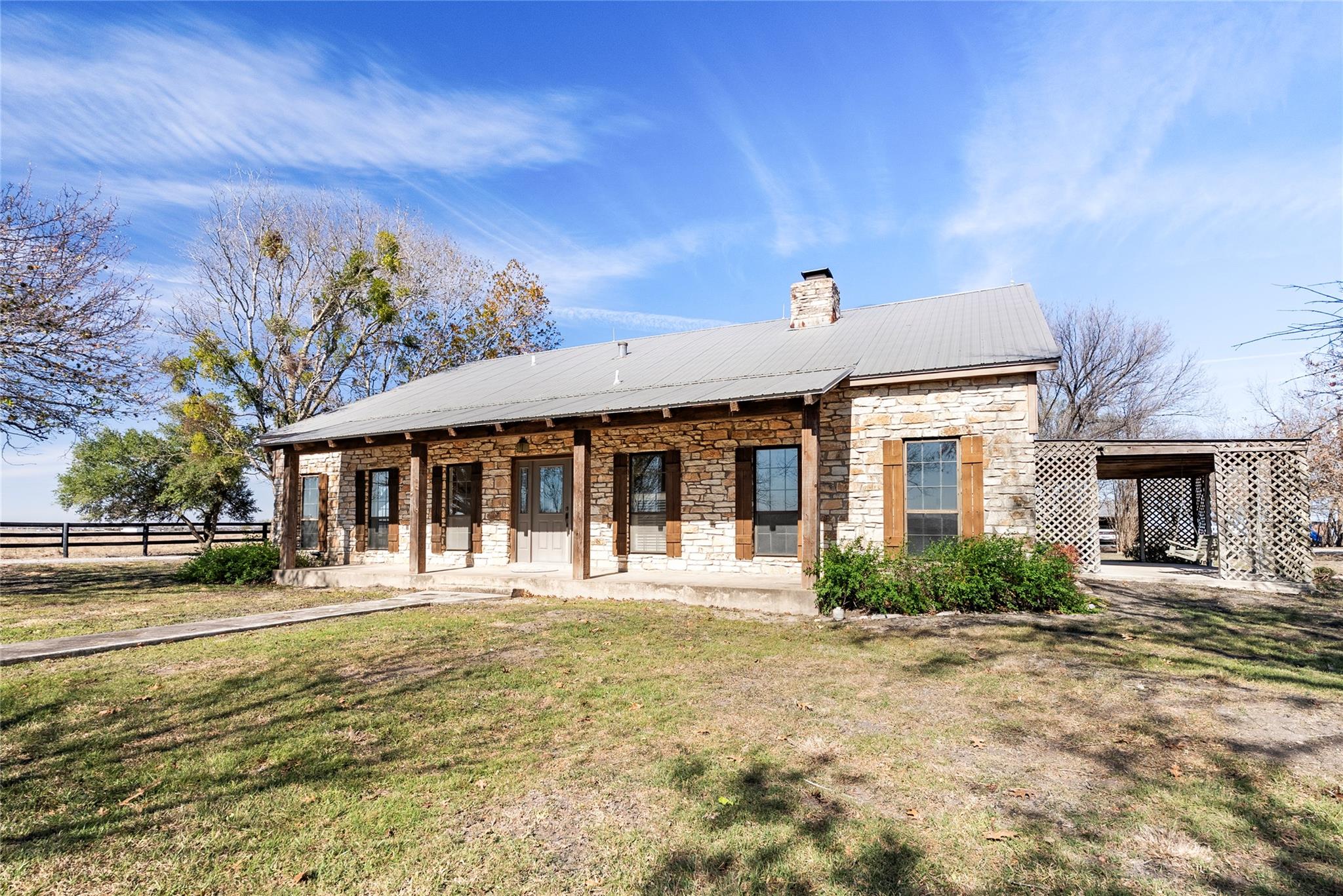 View of front of property featuring stone siding,