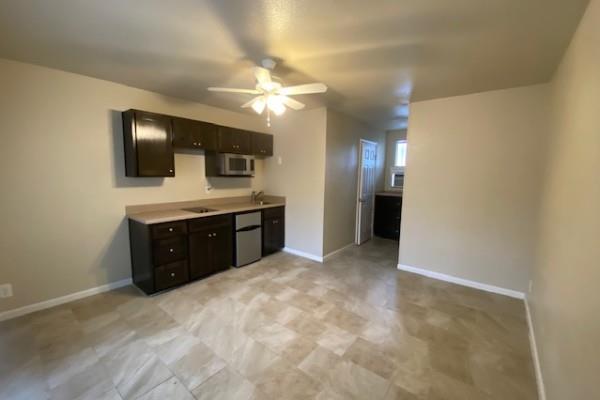 Kitchen featuring dark wood finish cabinetry, a c