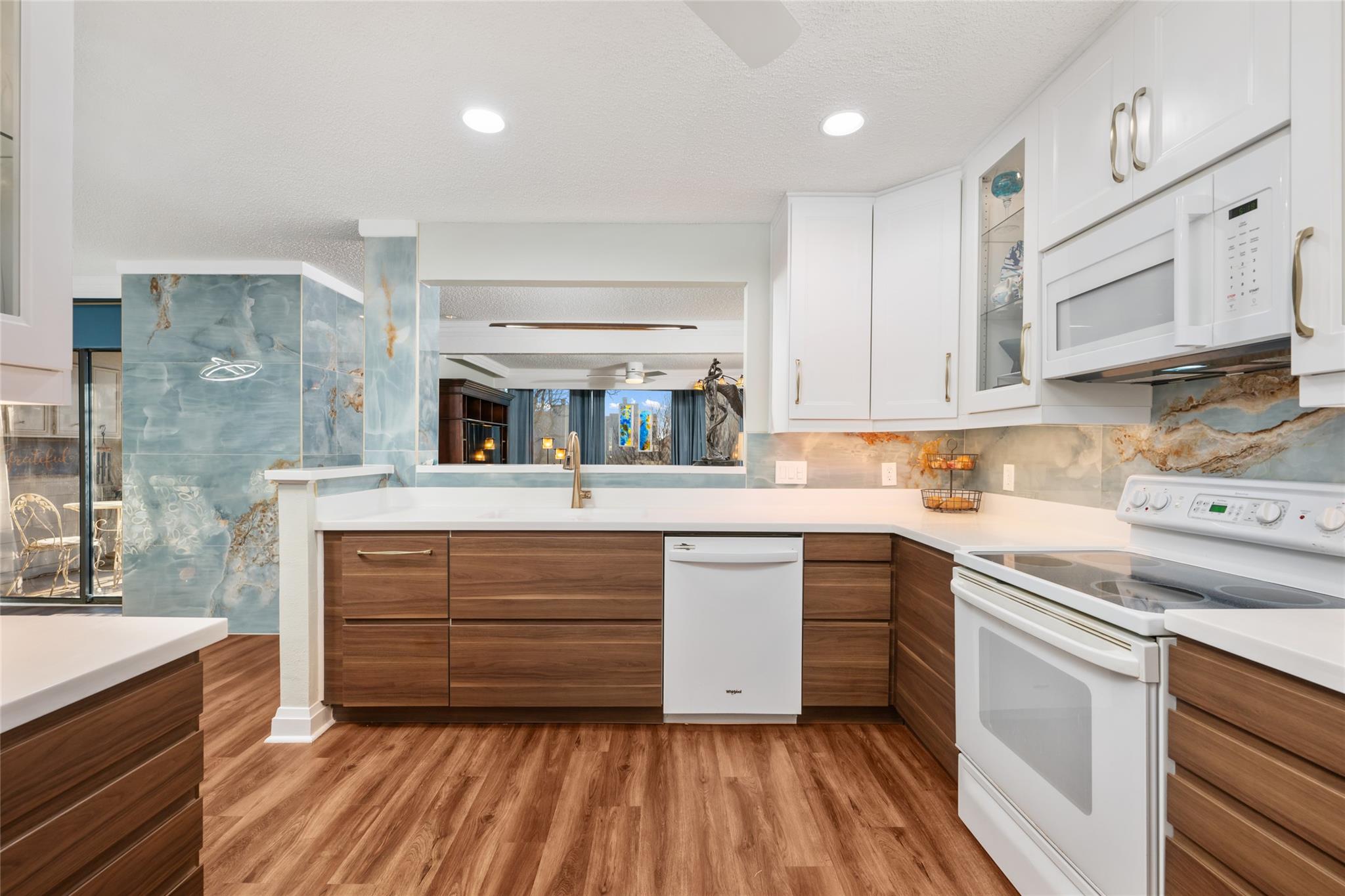 Kitchen with white appliances, dual tone cabinetr