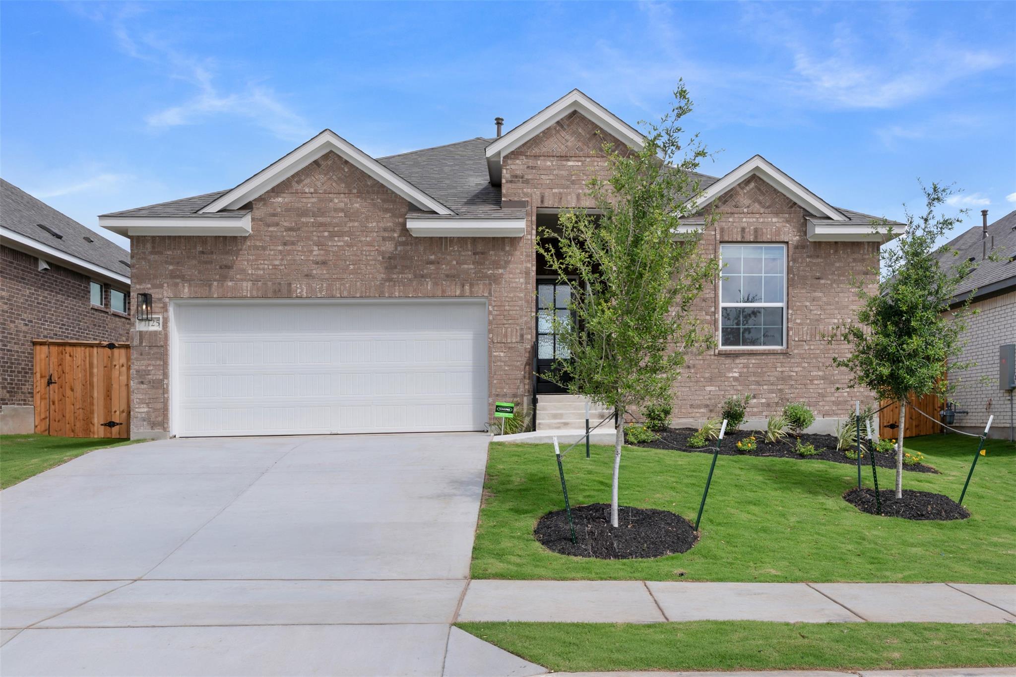 Brick veneer exterior with gabled roofline, featu