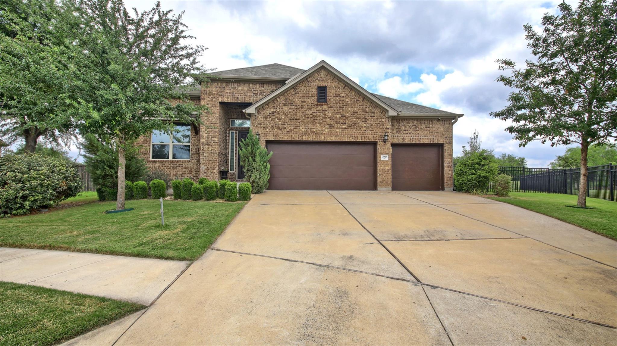 The property features a brick exterior, a drivewa