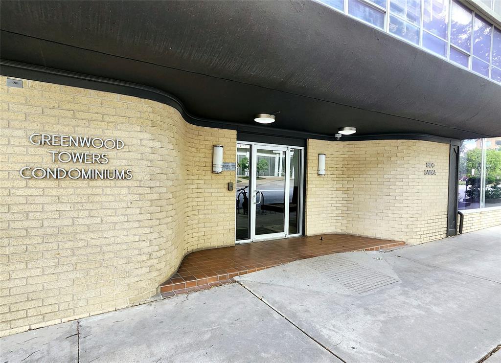 Entrance to property featuring brick siding