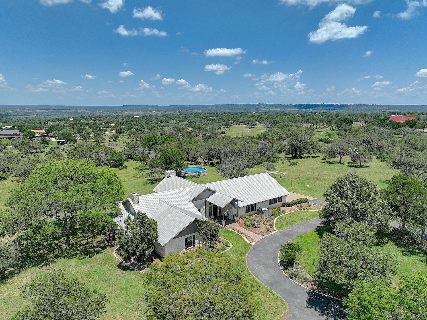 Rolling green hills surround this custom-built ra