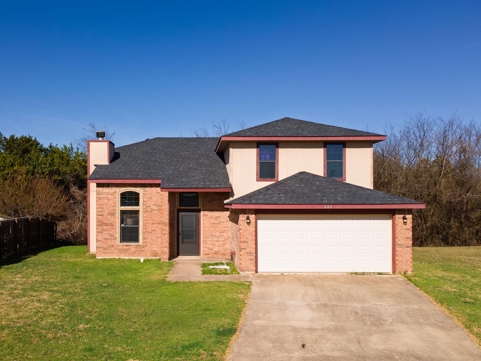 View of front of property featuring a chimney, a 