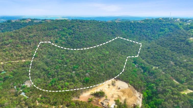 Expansive land parcel with dense tree coverage, o
