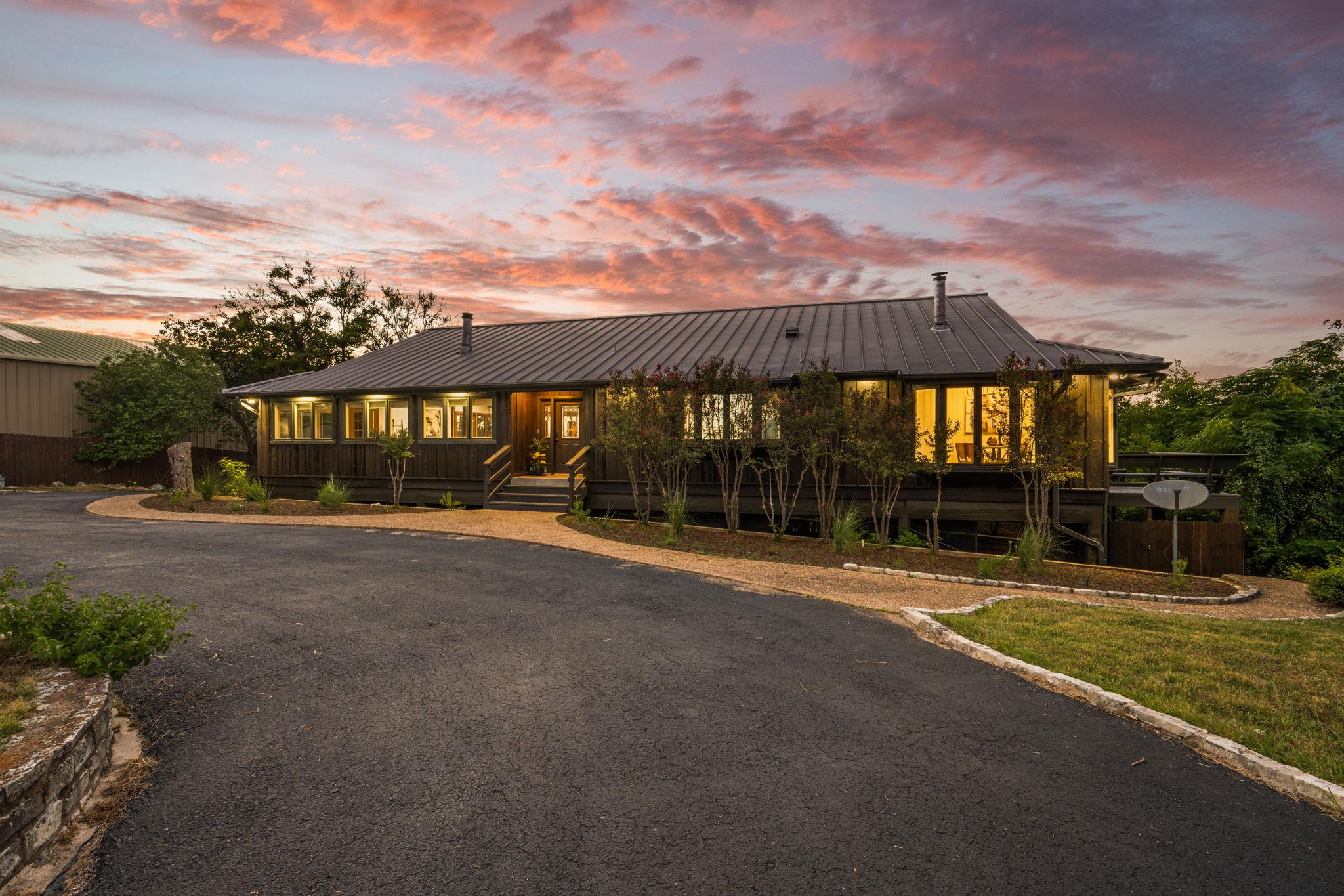 An inviting exterior with a wide driveway and lan