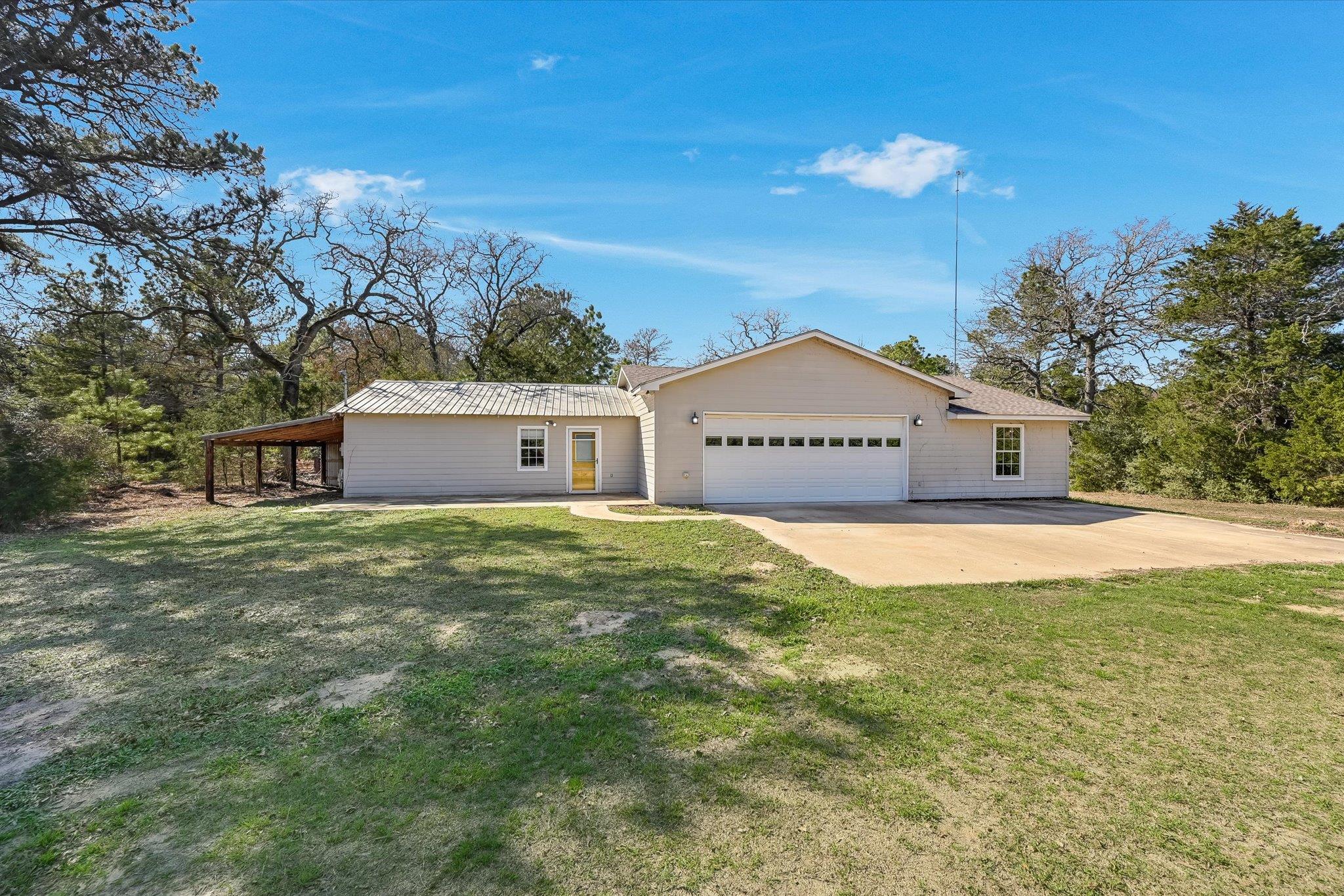 View of front of house featuring a garage, a fron