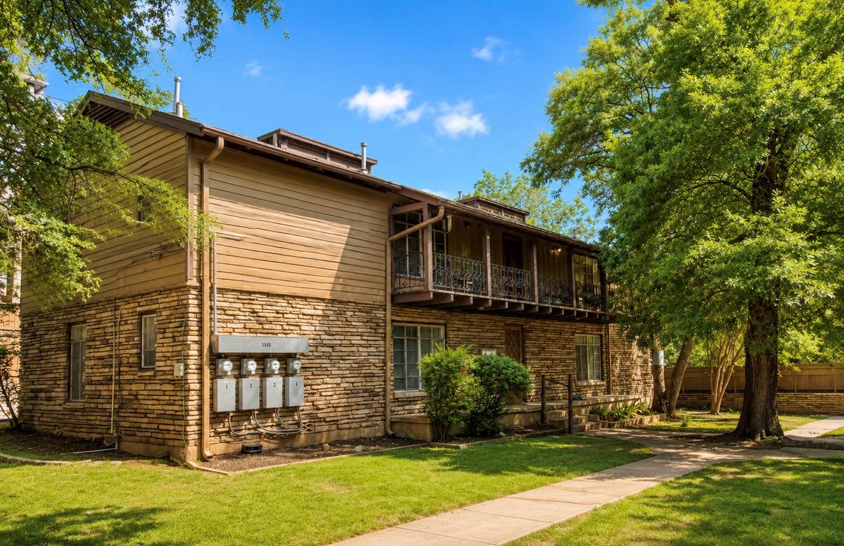 Mature trees and a meticulously maintained lawn f