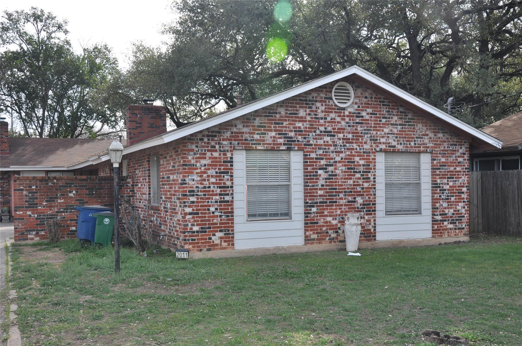 View of home's exterior with brick siding and a c