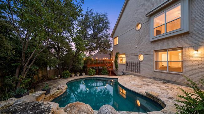An inviting backyard oasis awaits with a custom s