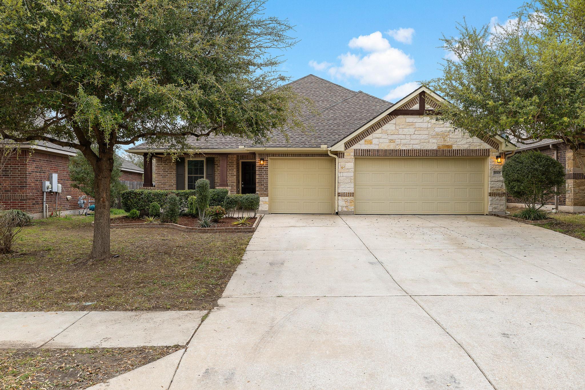 View of front facade featuring an attached garage