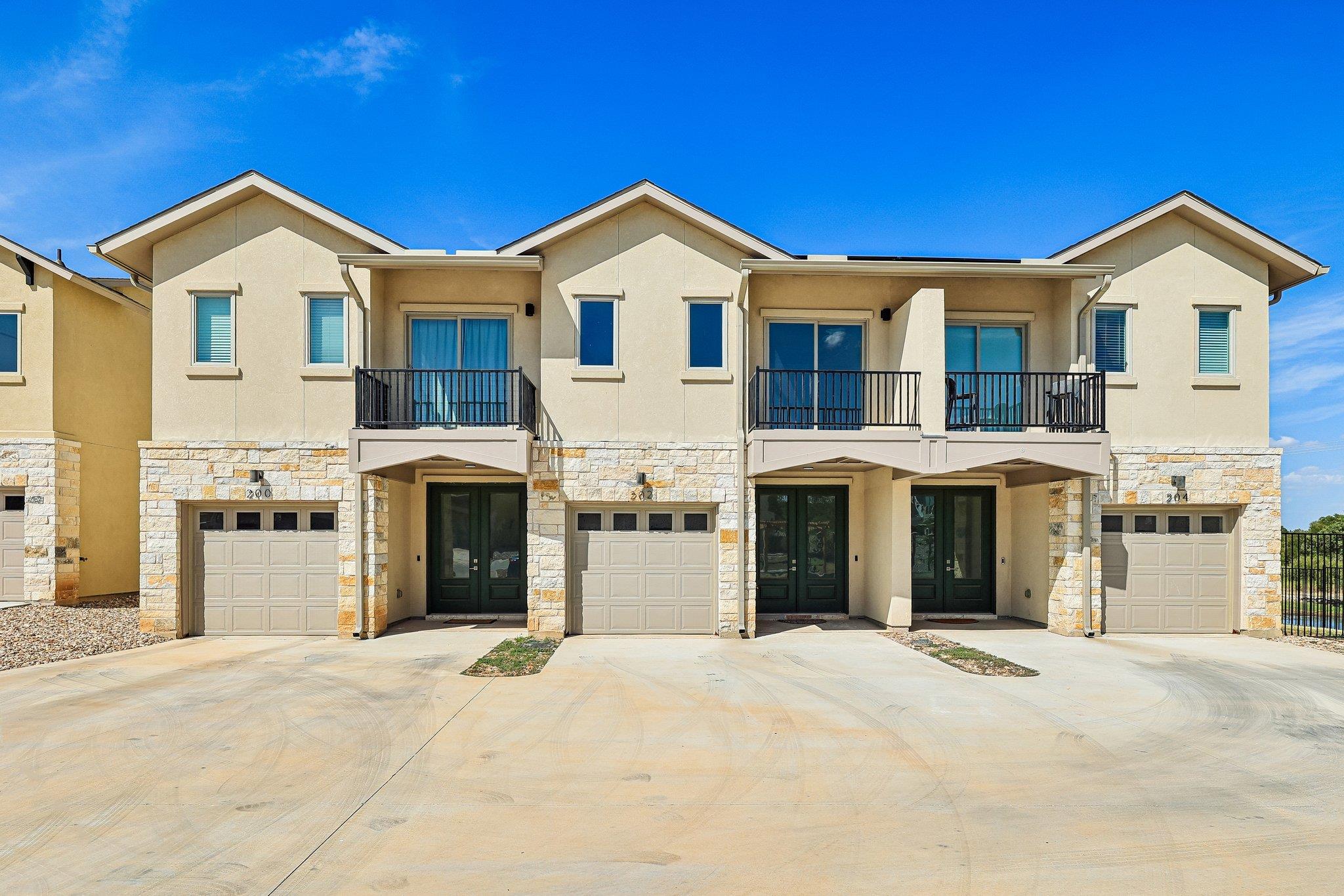 Multi-level townhomes showcase stone accents, pri