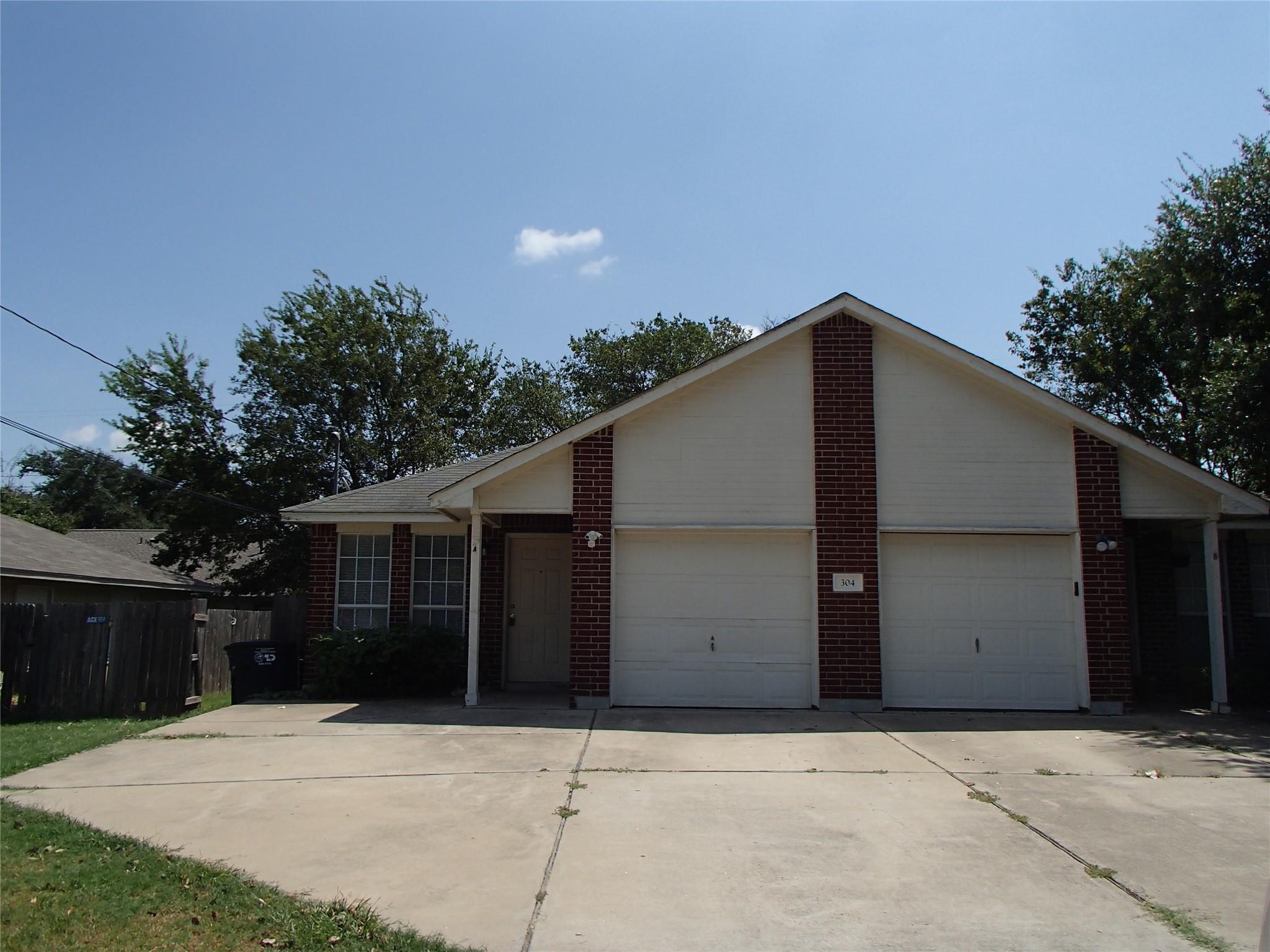 View of front of home featuring a garage, drivewa