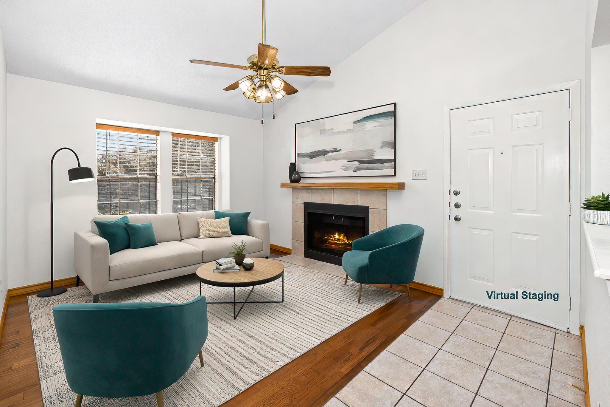 Living area with a tiled fireplace, light wood-st