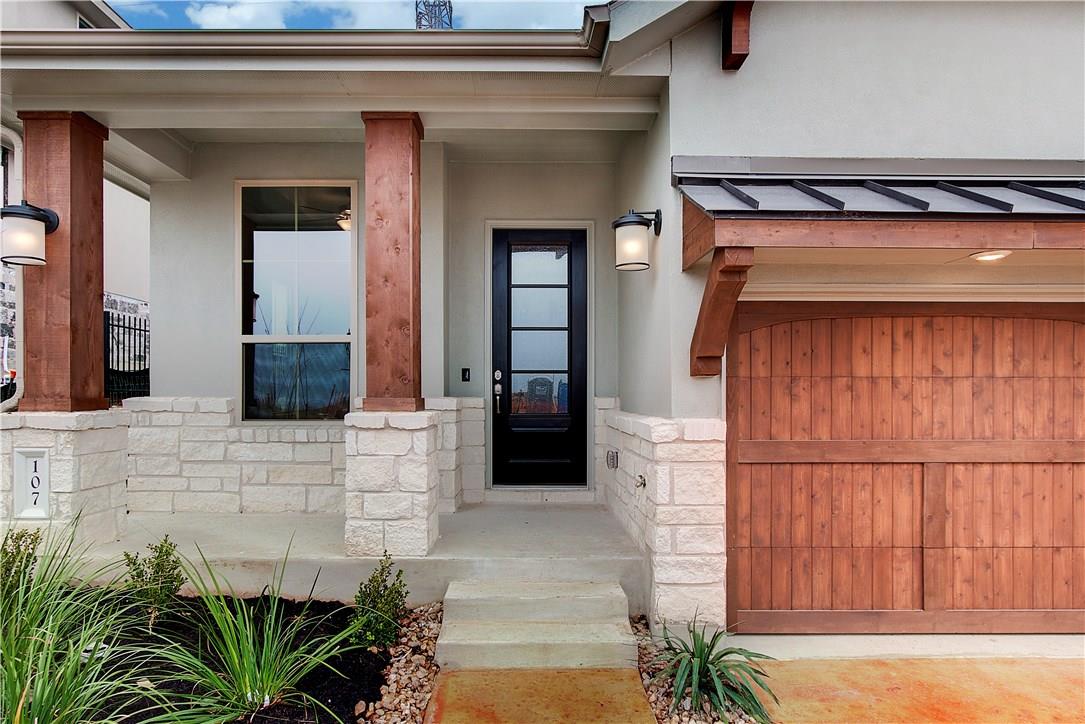 Property entrance with stone siding, stucco sidin