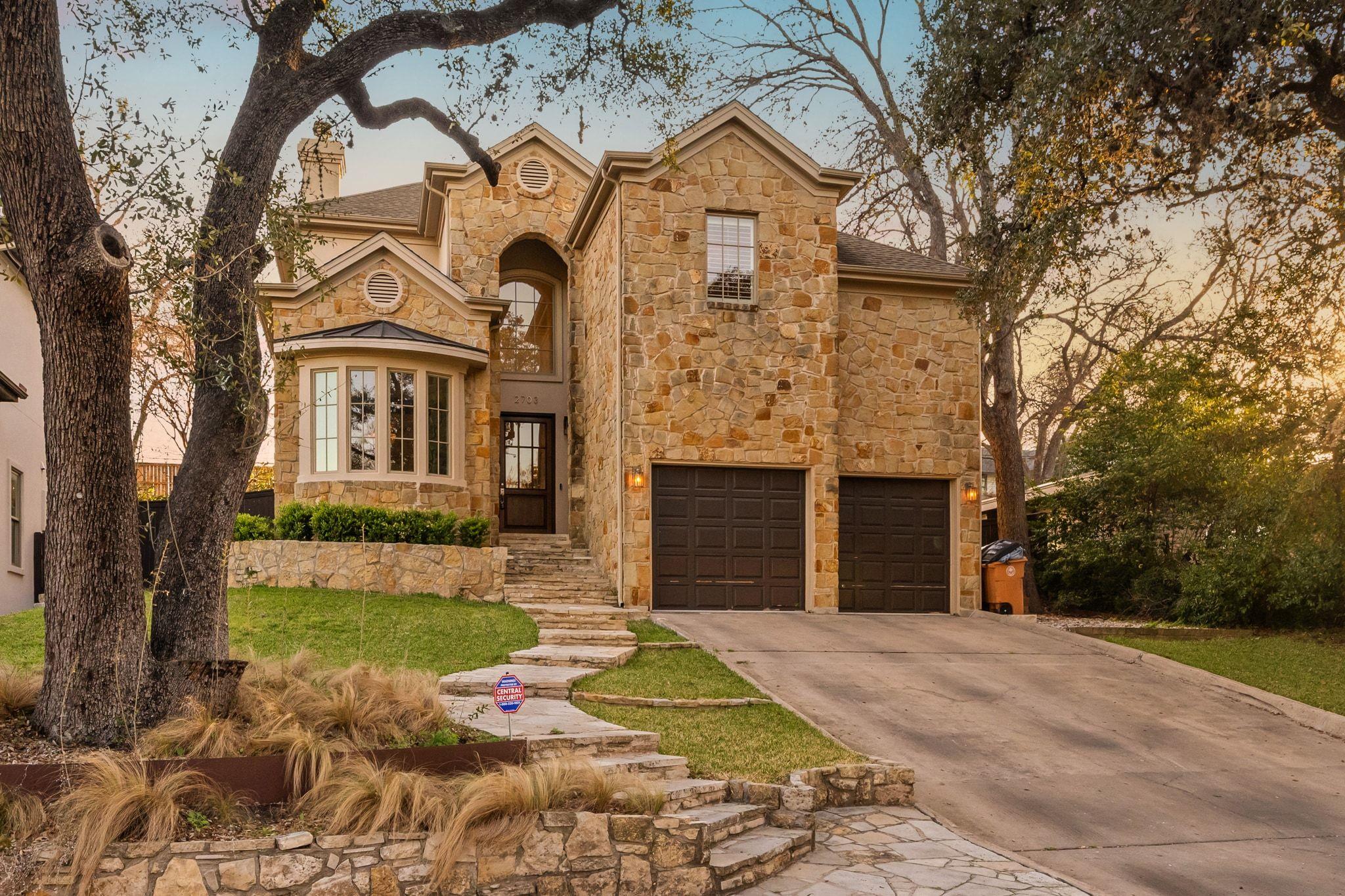View of front facade featuring stone siding, conc