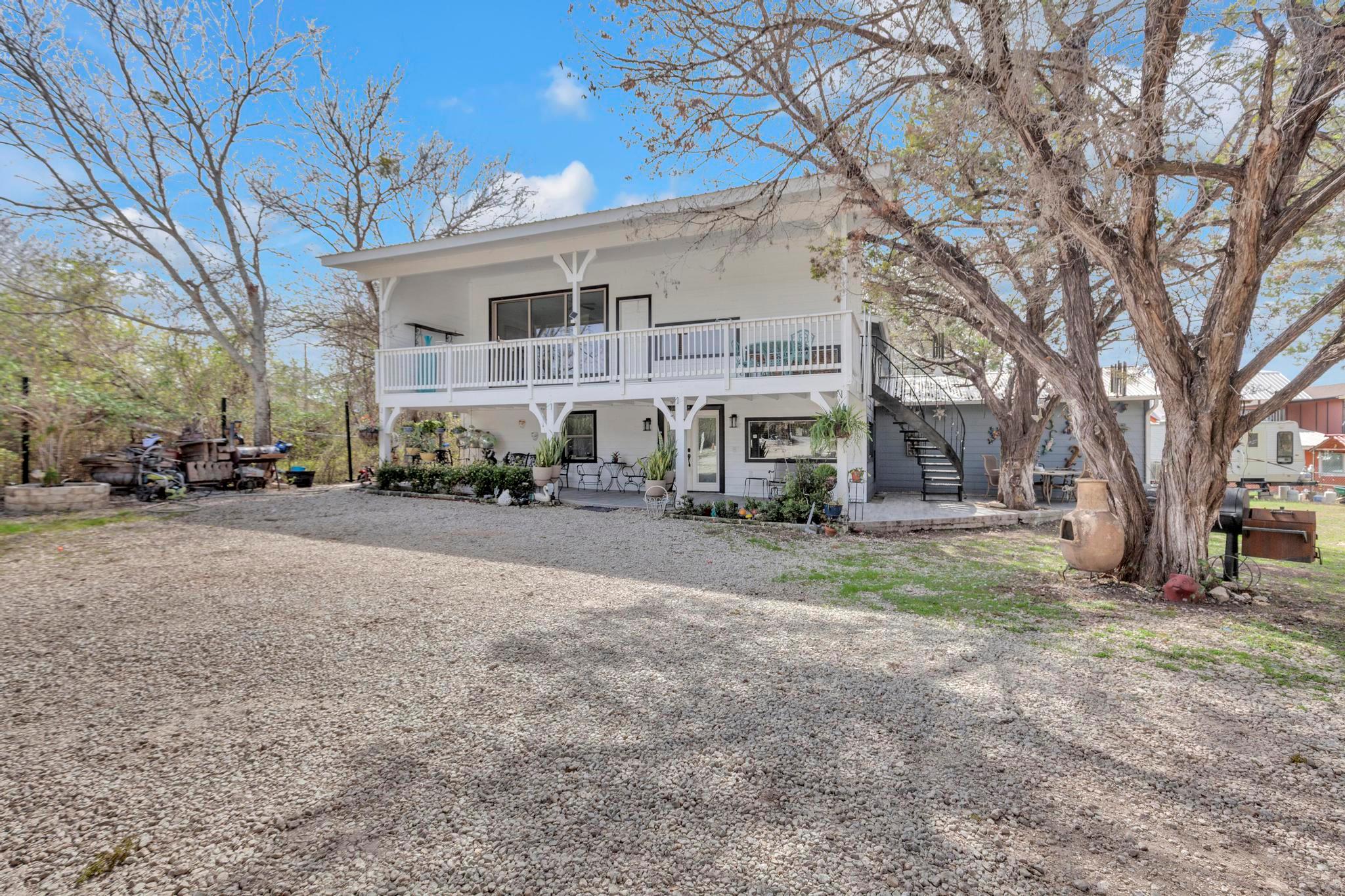 View of front of house with a patio area and a po