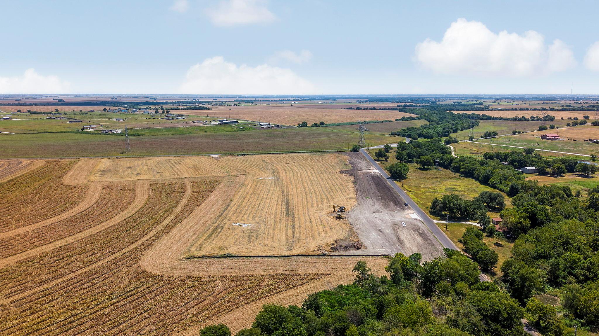 A vast expanse of rural land stretches toward the