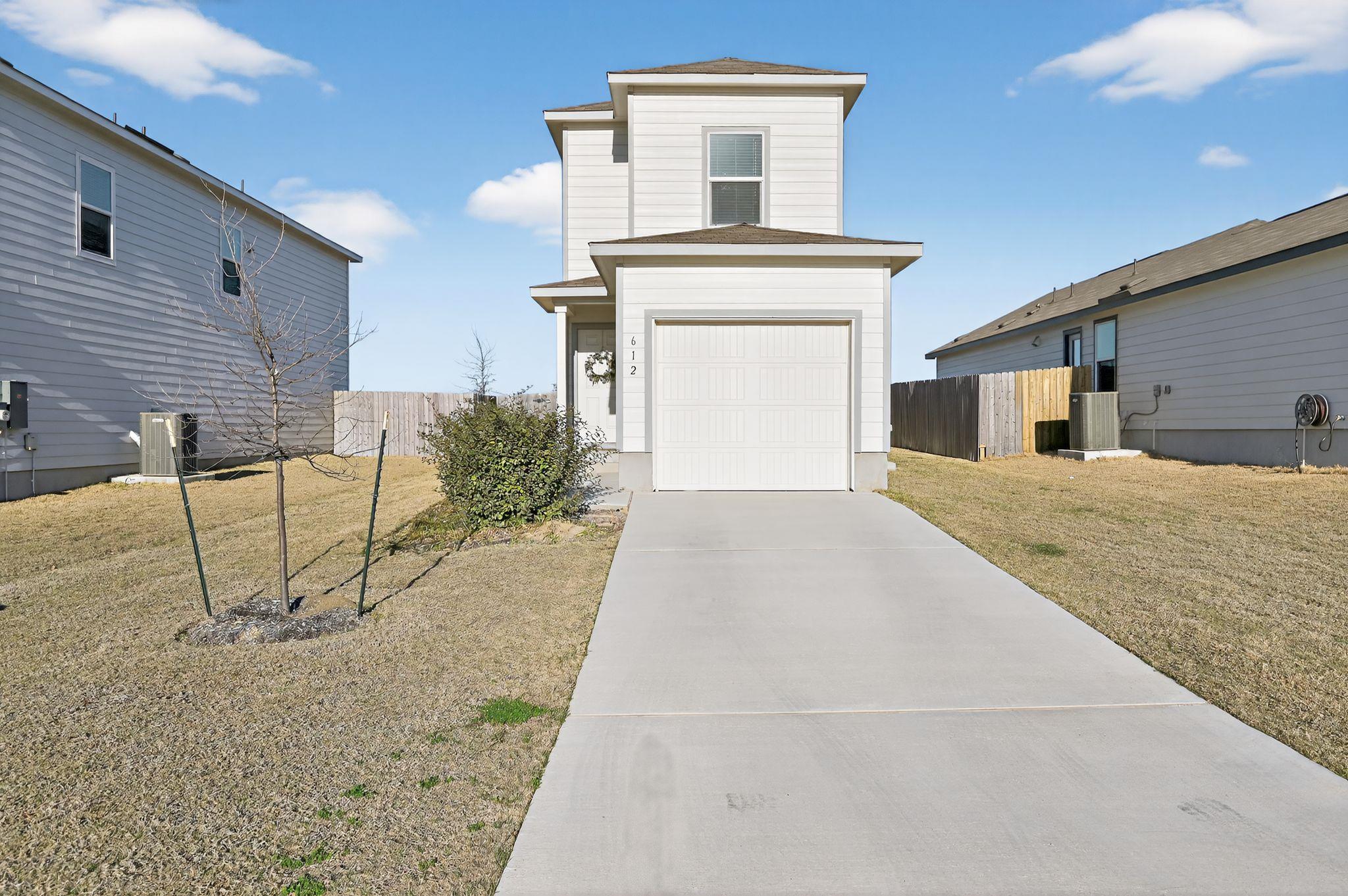 View of front of property featuring concrete driv