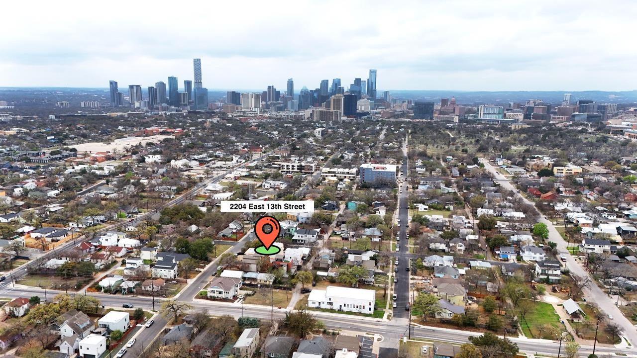 Aerial view of property's location with city skyl
