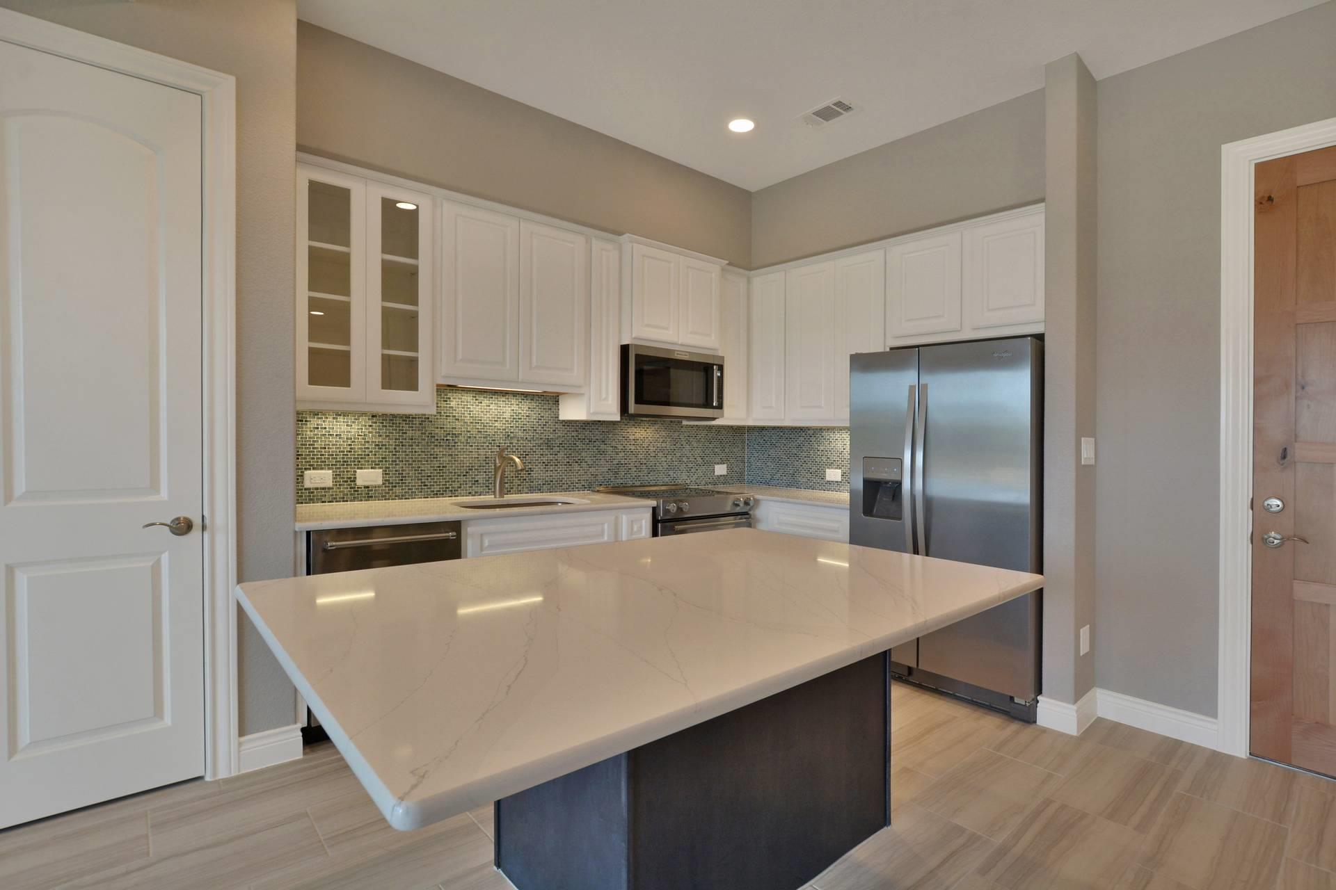 Kitchen with stainless steel appliances, glass fr