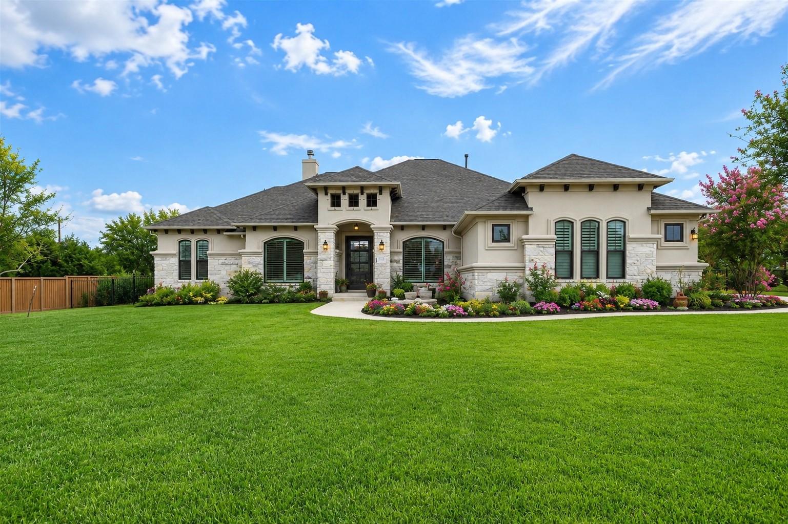 A well-maintained lawn and vibrant flower beds en