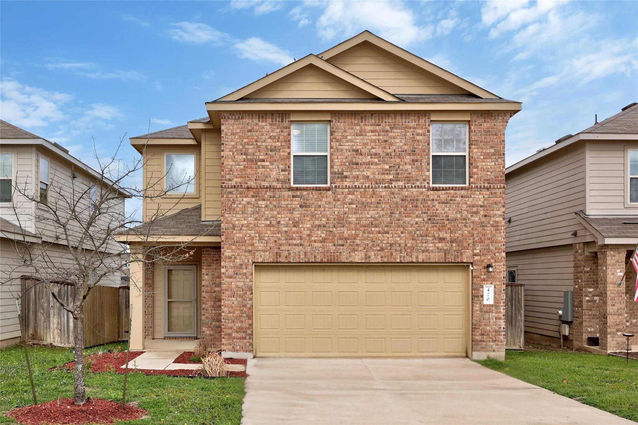View of front facade featuring brick siding, driv