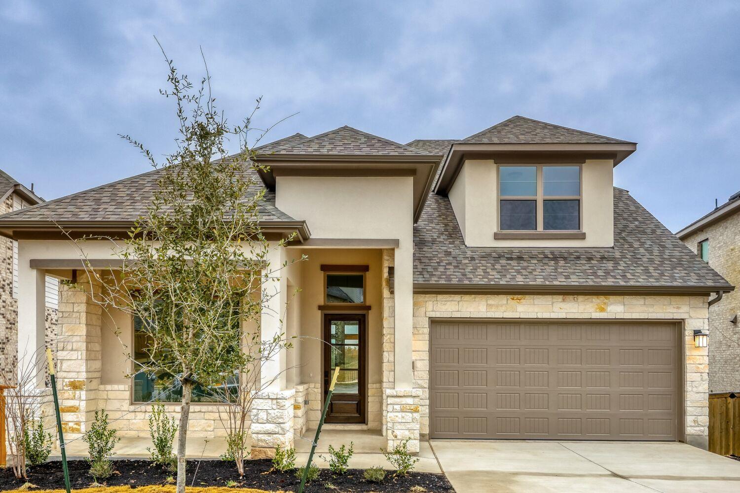 View of front of house featuring stone siding, ro