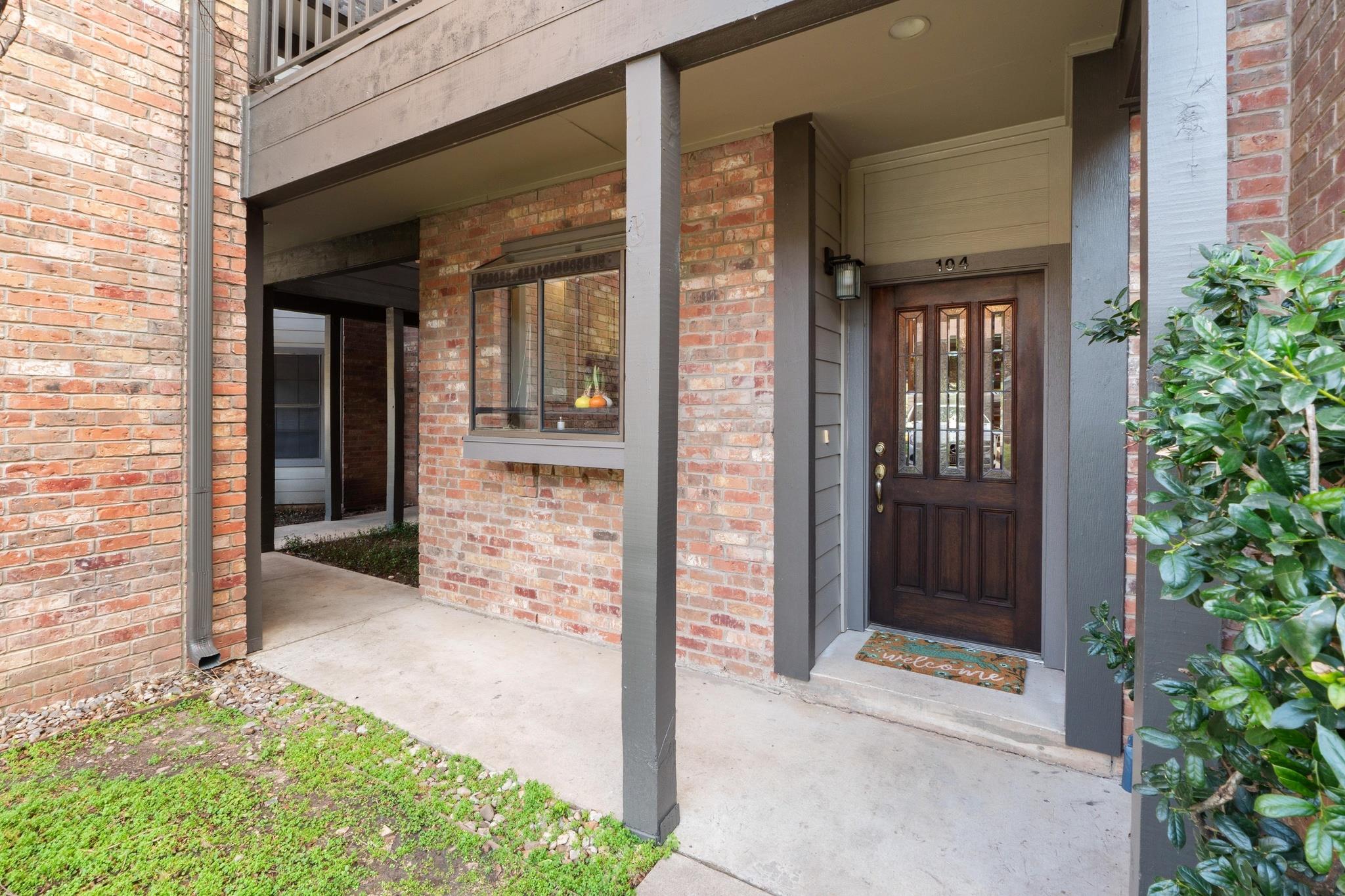 Doorway to property with brick siding