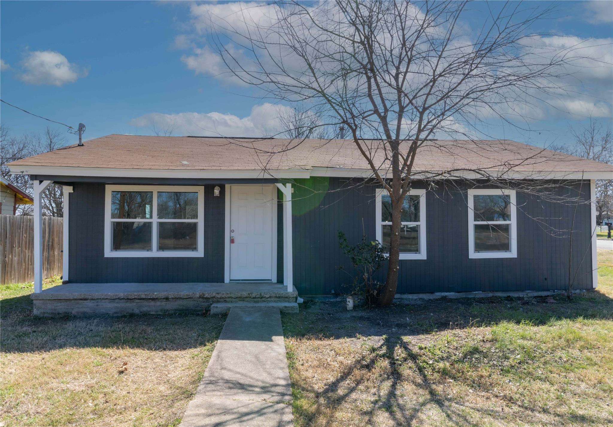 Charcoal exterior with white trim, a brown shingl
