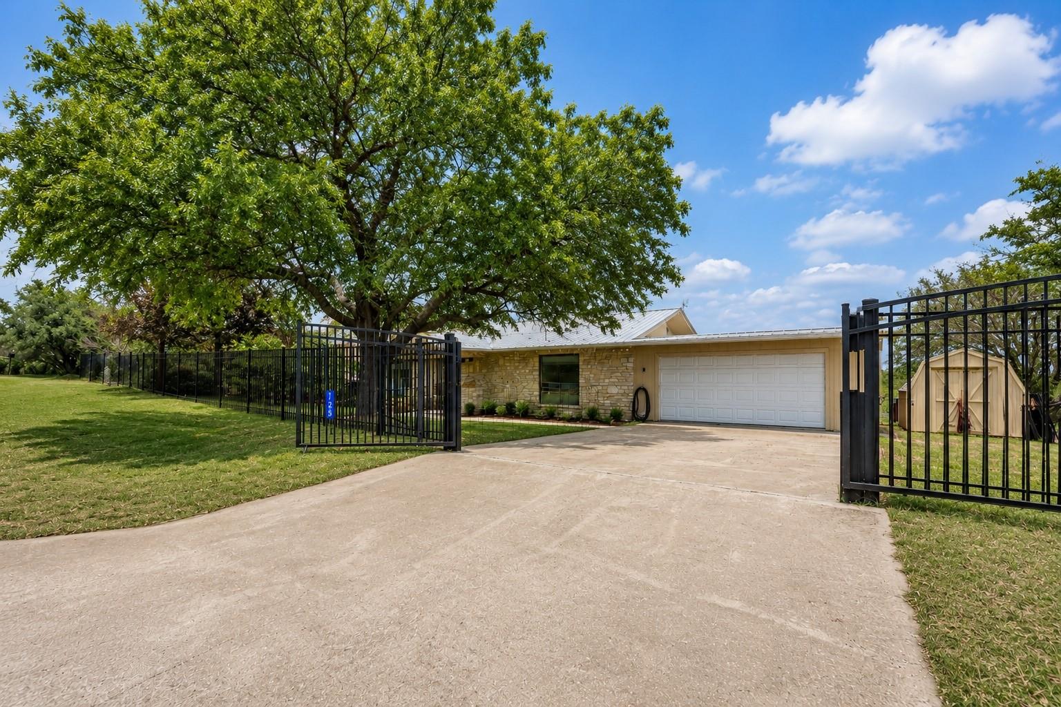 A private estate with a large, mature tree framin