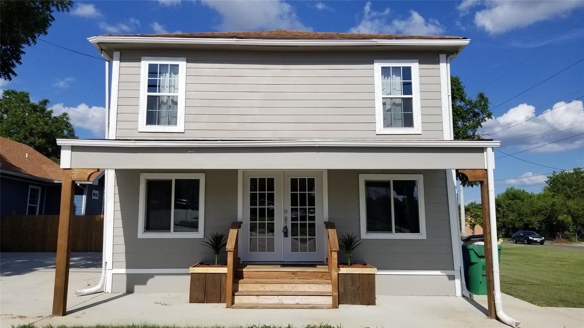 A welcoming façade features a covered porch and f