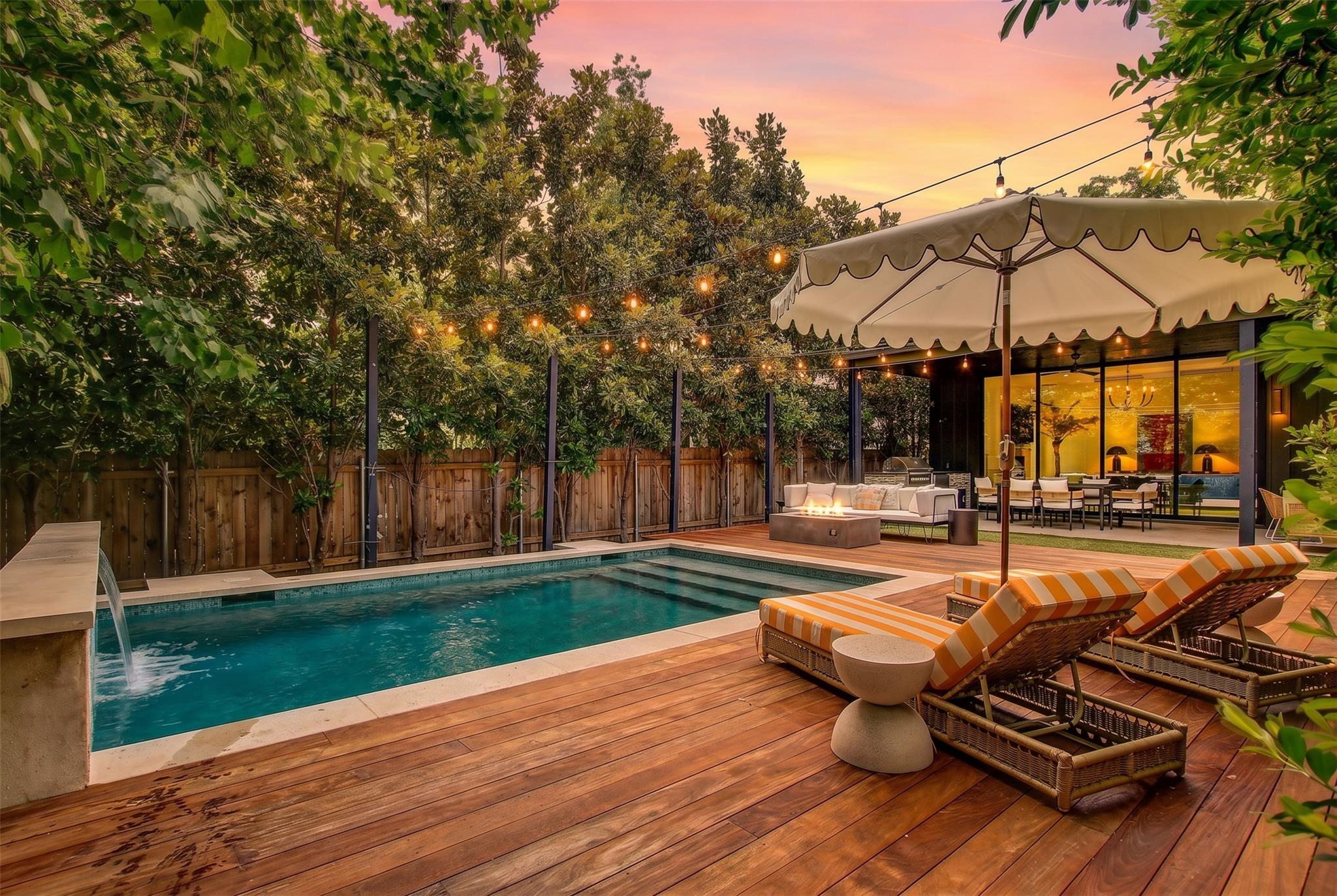 An inviting backyard oasis offers a sparkling poo