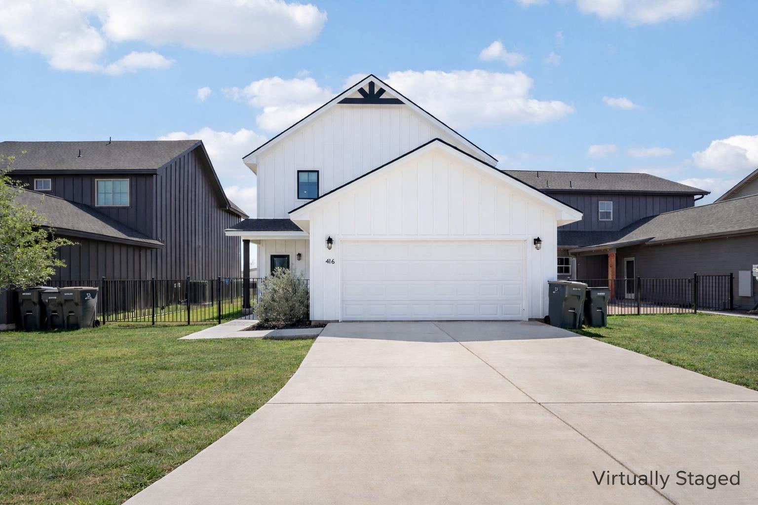 Modern farmhouse with an attached garage, board a