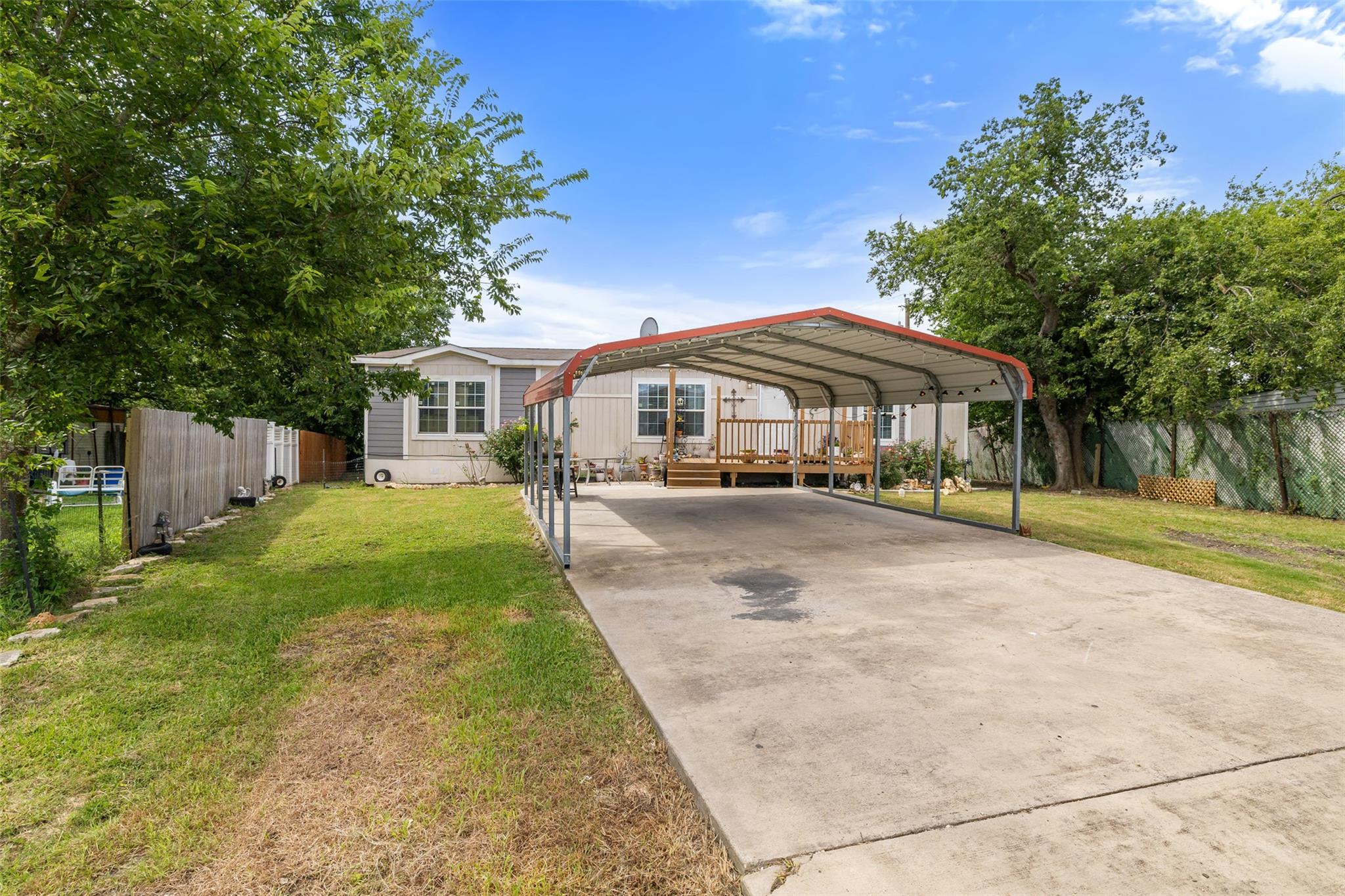Manufactured / mobile home featuring a deck, driv