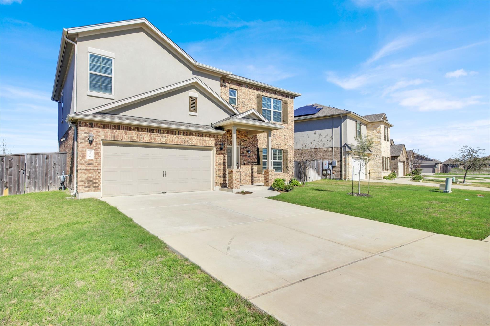 View of front of home with concrete driveway, stu
