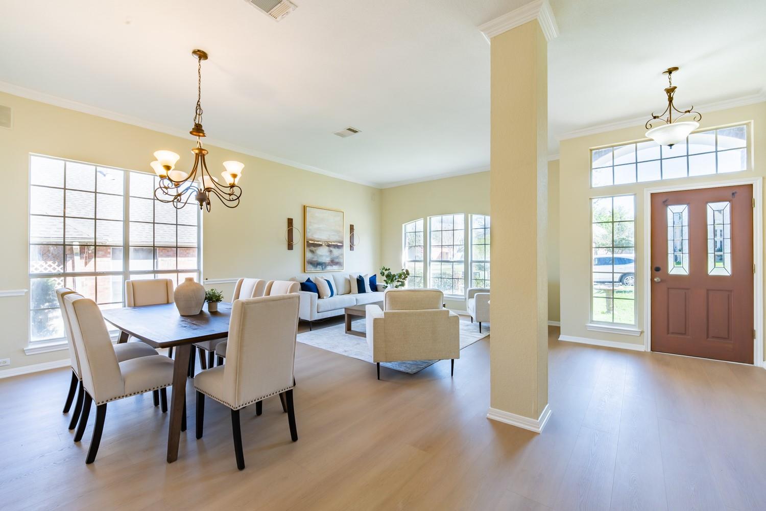 Dining area featuring hanging lights, crown moldi