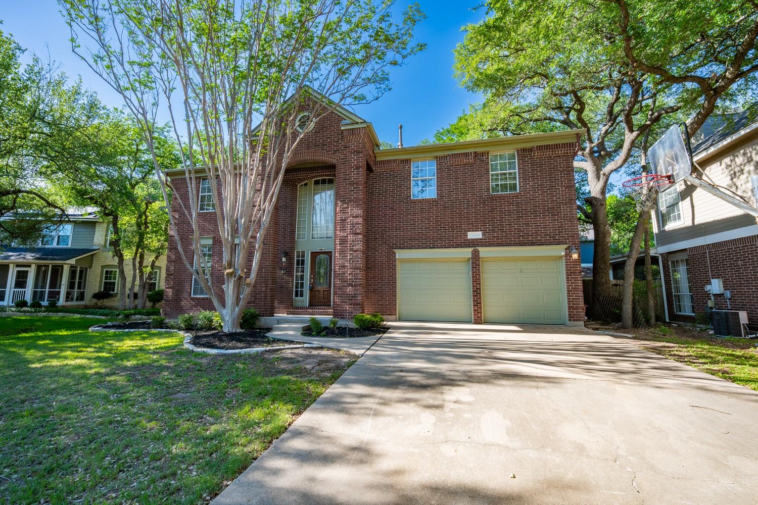 Brick exterior featuring a tall arched entry, a t