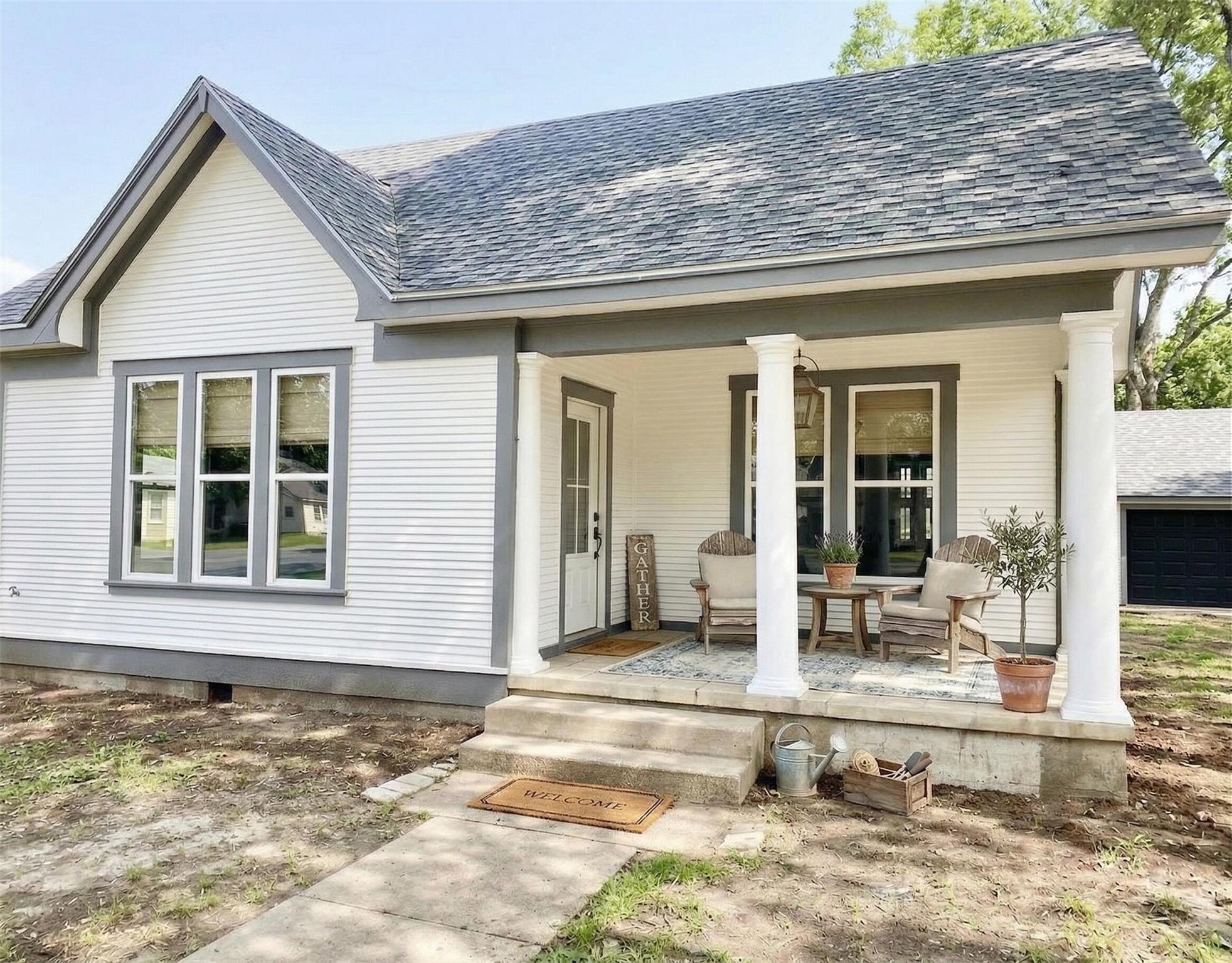 View of front of house featuring a porch, a shing