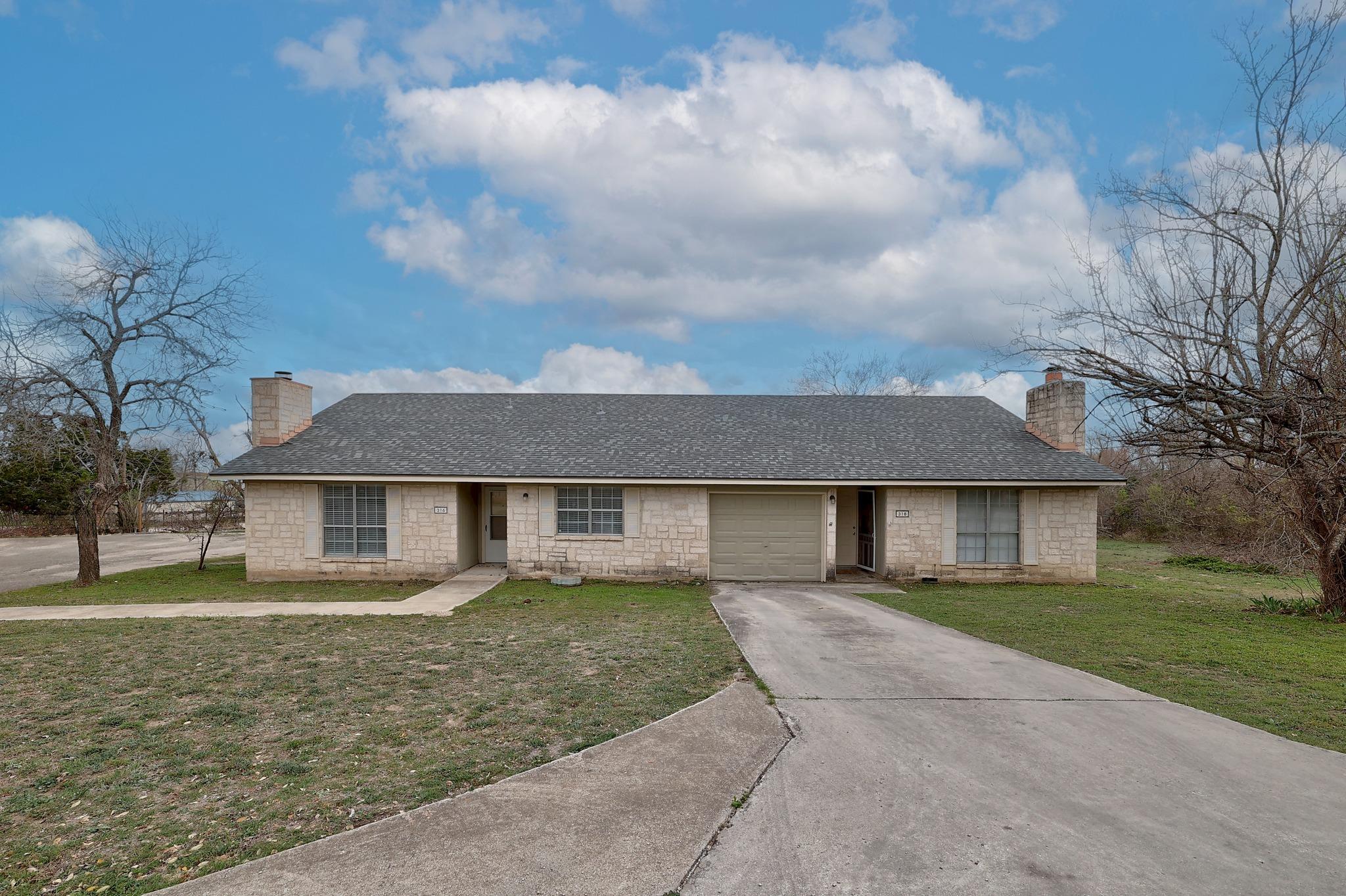 Ranch-style house with a chimney, a shingled roof