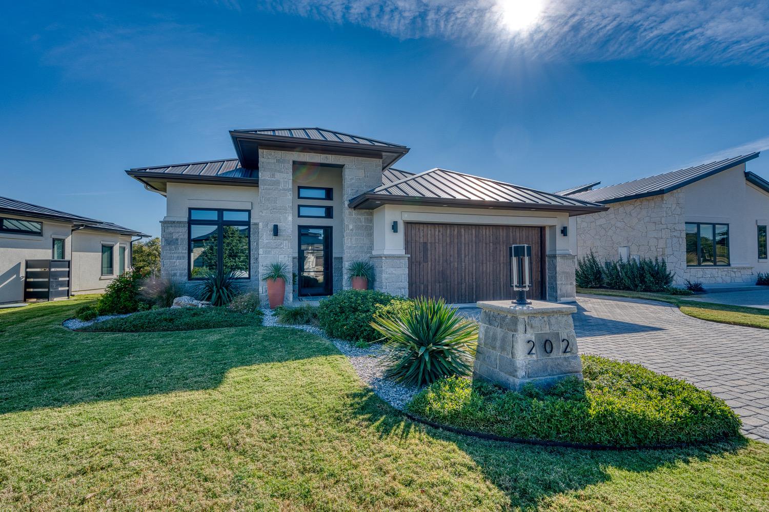 A striking modern facade with stone accents and l
