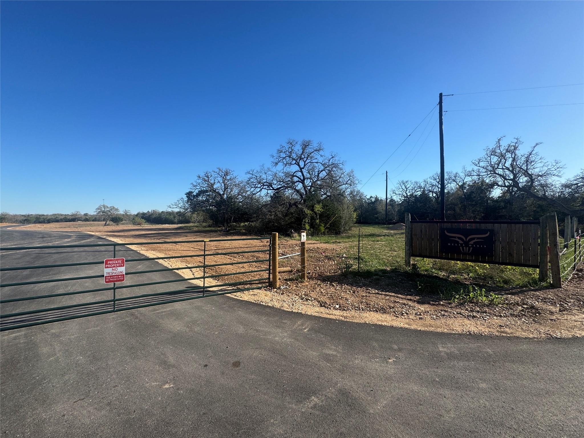 View of asphalt road with a gate