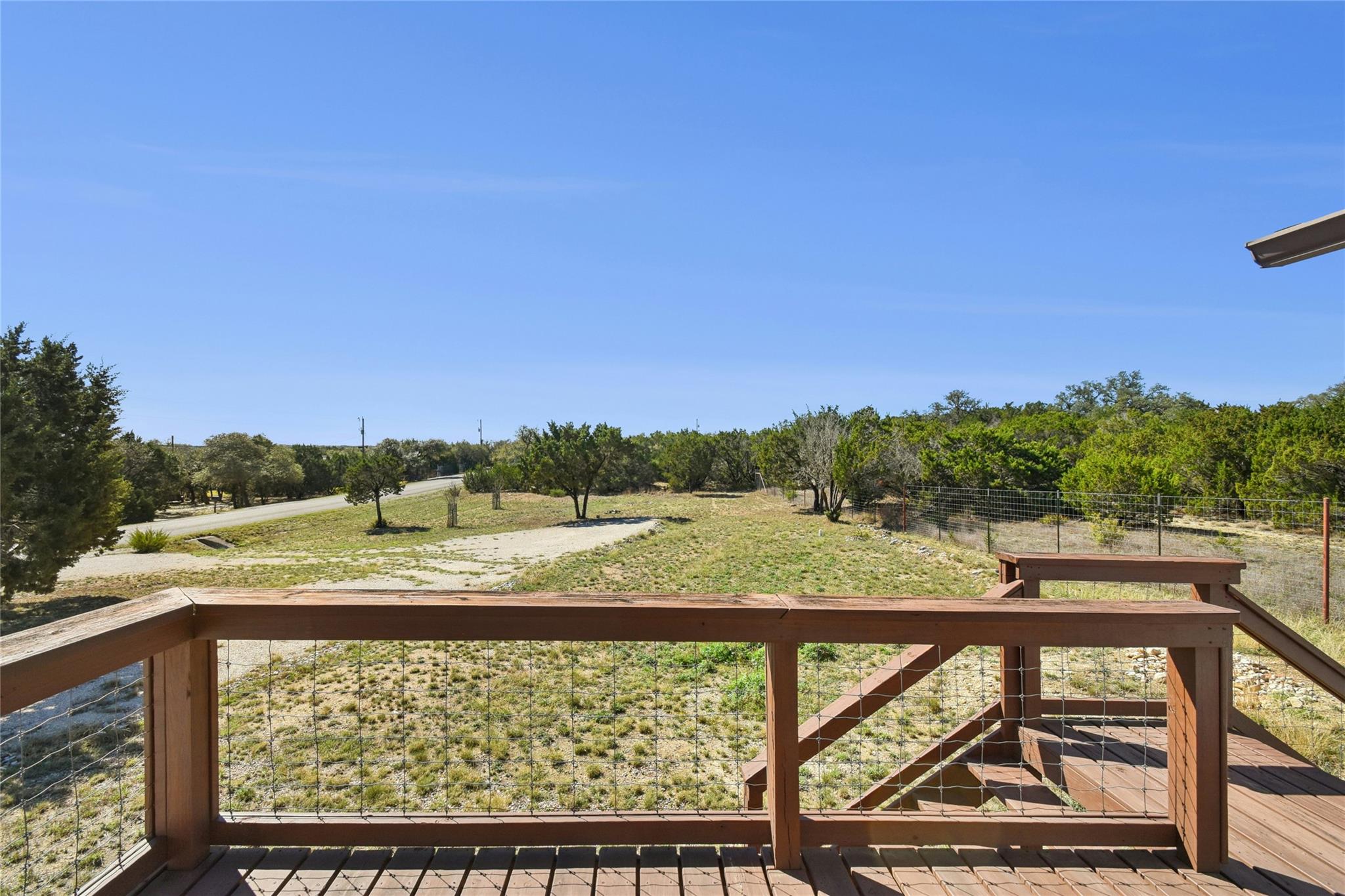View of yard featuring a rural view and a wooden 