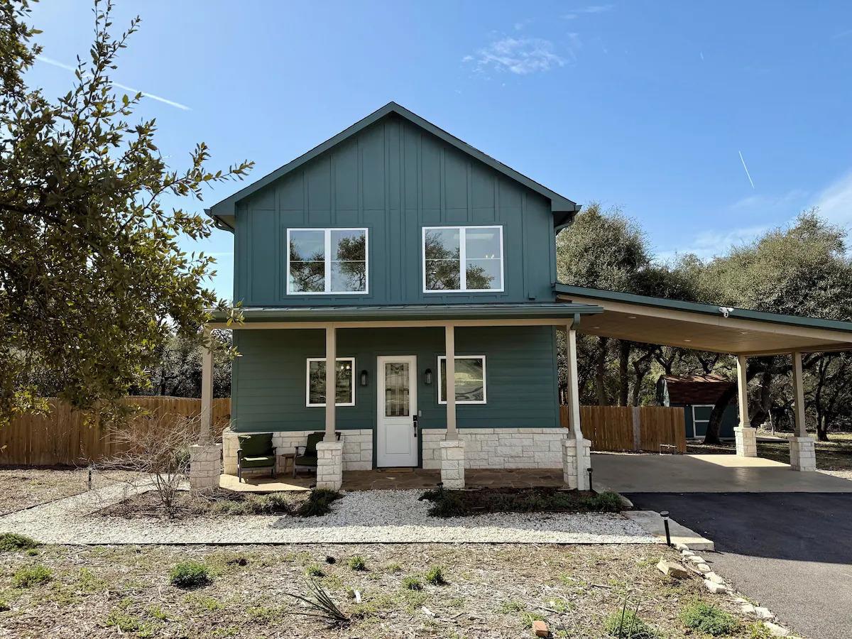 View of front of house with a porch, an attached 