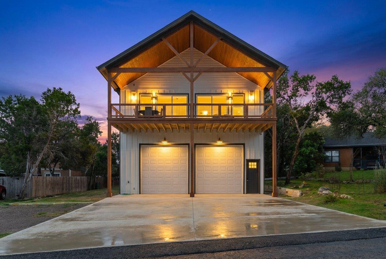 View of front of property with a garage, driveway