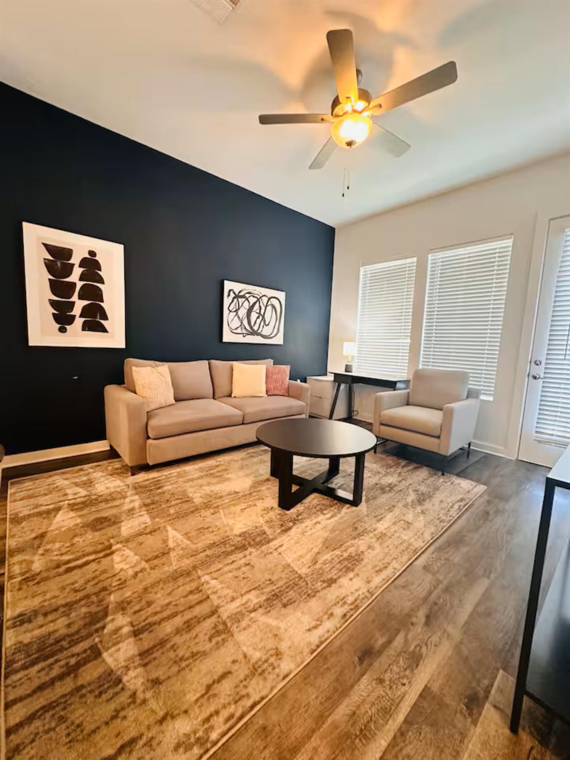 Living room featuring ceiling fan, wood finished 
