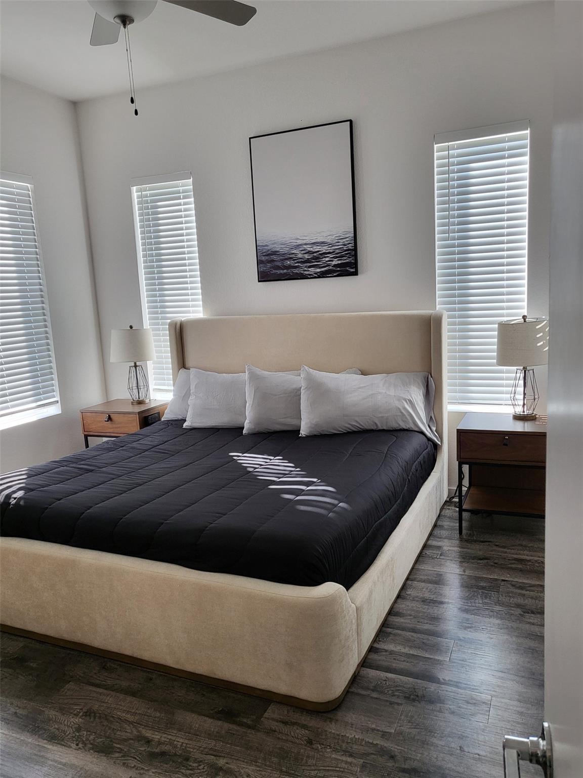 Bedroom featuring dark wood-style flooring and ce