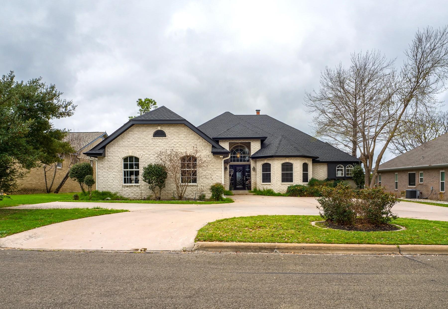 French country style house with brick siding, a f