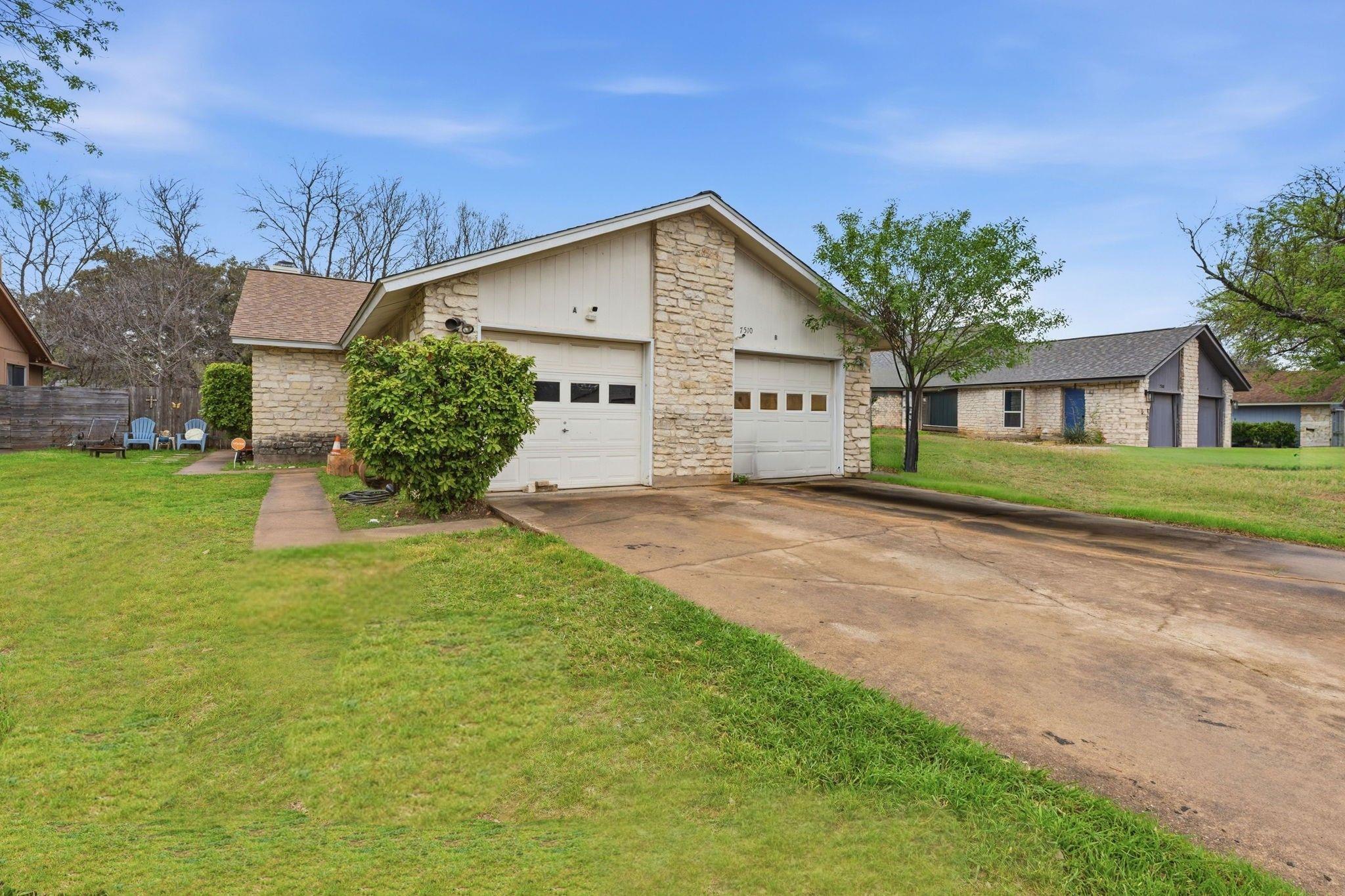 View of front of property with stone siding, a fr