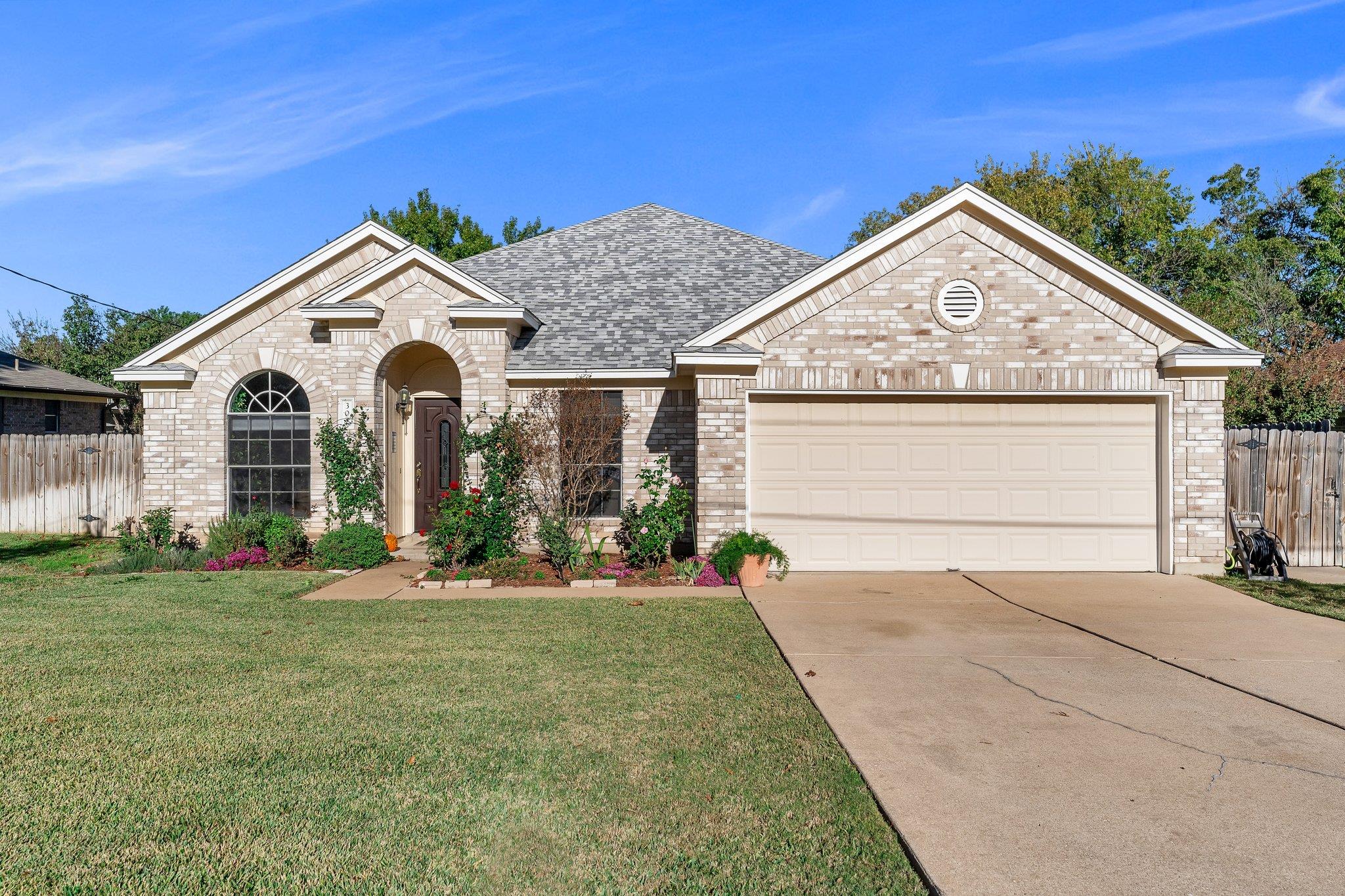 View of front of property with brick siding, an a